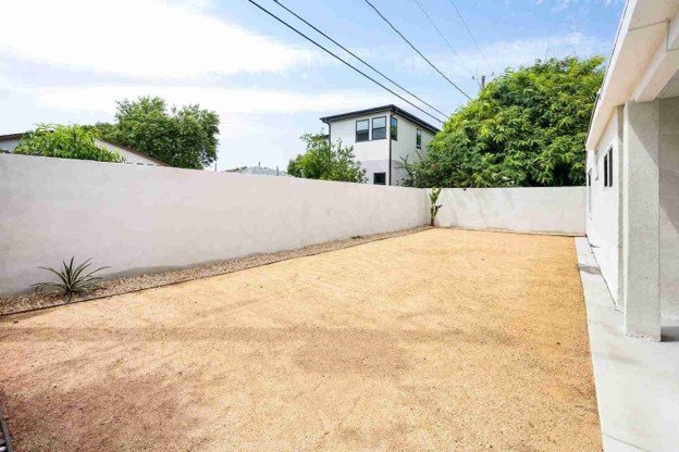 Empty residential backyard space prepared for a new custom deck or outdoor living area